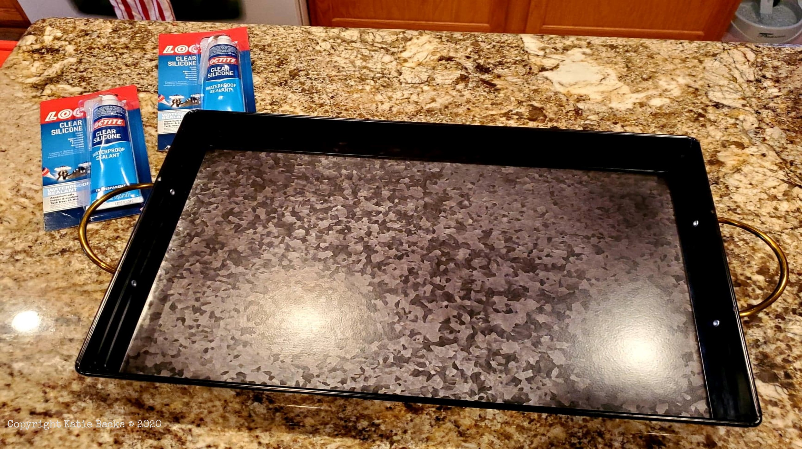 Metal tray and silicone tubes on the kitchen counter