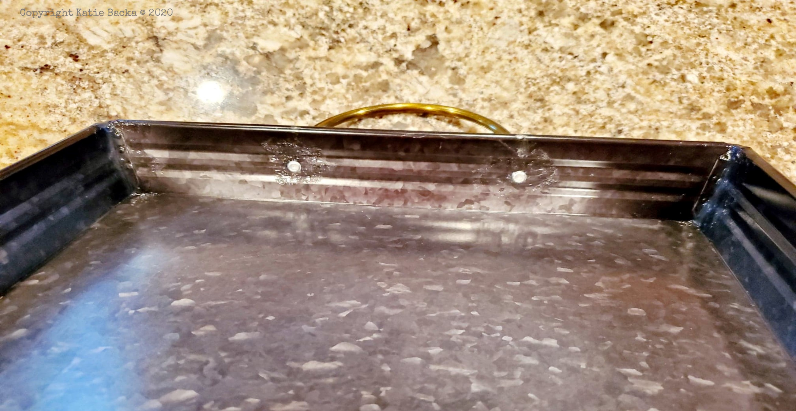 Metal tray with silicone seals on the kitchen counter